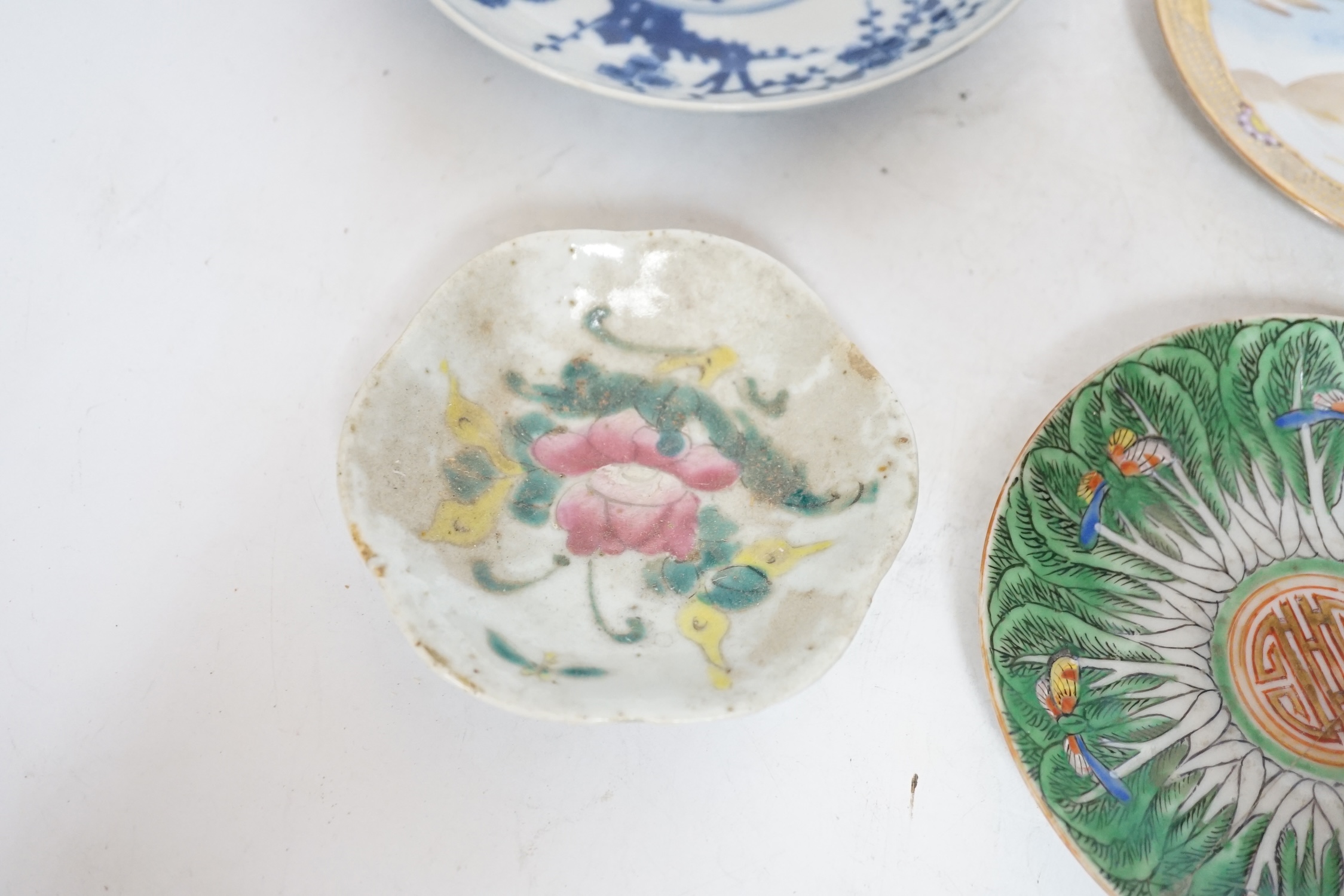 Four Chinese or Japanese porcelain saucers, largest 16.5 cm diameter